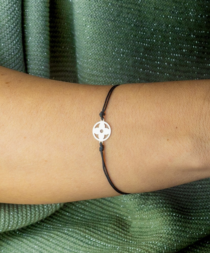 Black string bracelet with a silver pendant
