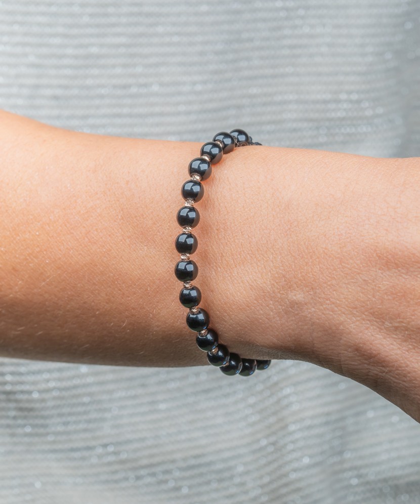 Black string bracelet with gold and onyxes