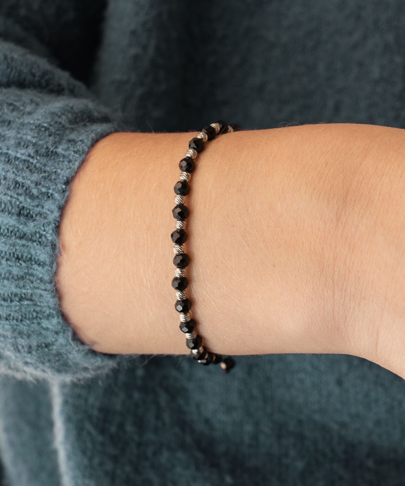 Black string bracelet with silver and onyxes