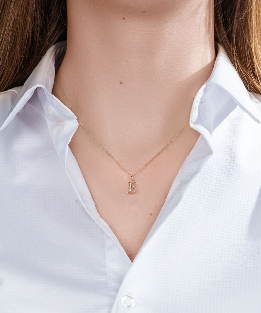 Gold pendant with zircons Letter E