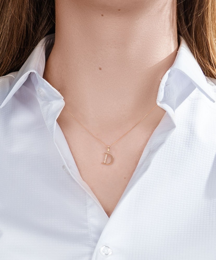 Gold pendant with zircons Letter D