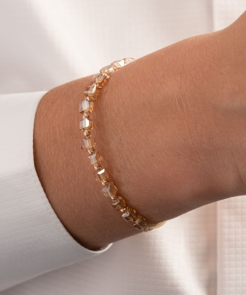 Champagne color string bracelet with gold and onixes