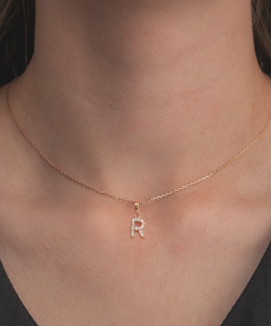 Gold pendant with zircons Letter R