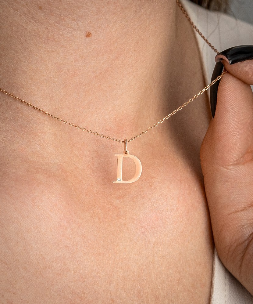Gold pendant with diamond letter D