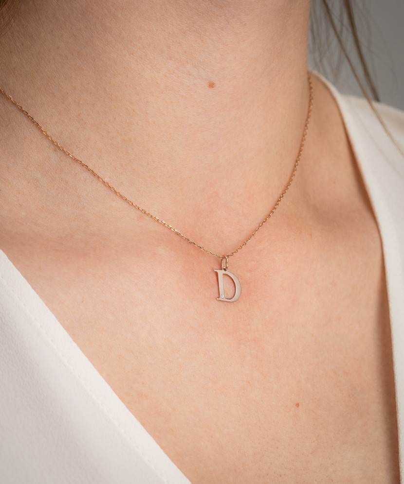 Gold pendant with diamond letter D