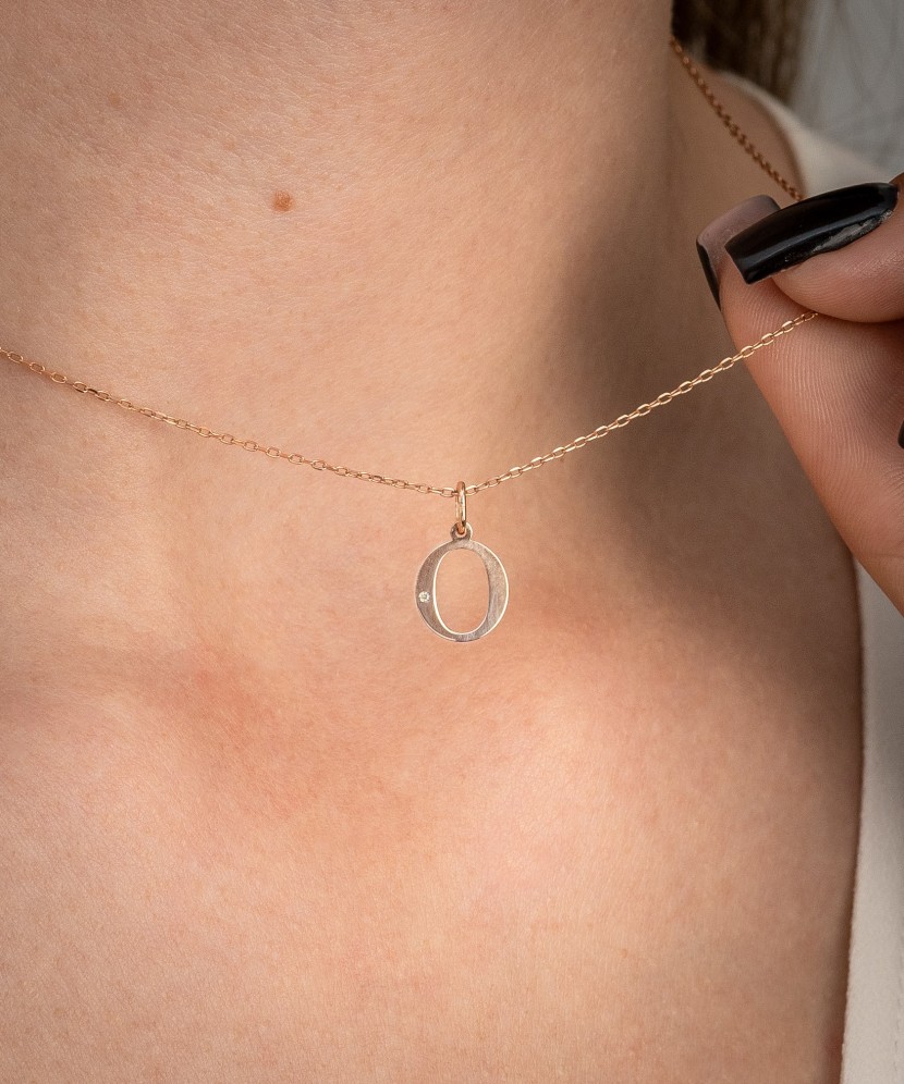 Gold pendant with diamond letter O