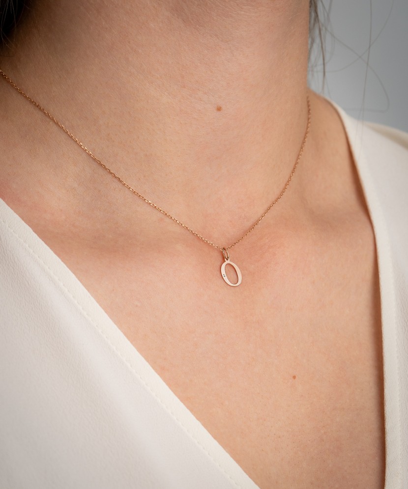 Gold pendant with diamond letter O