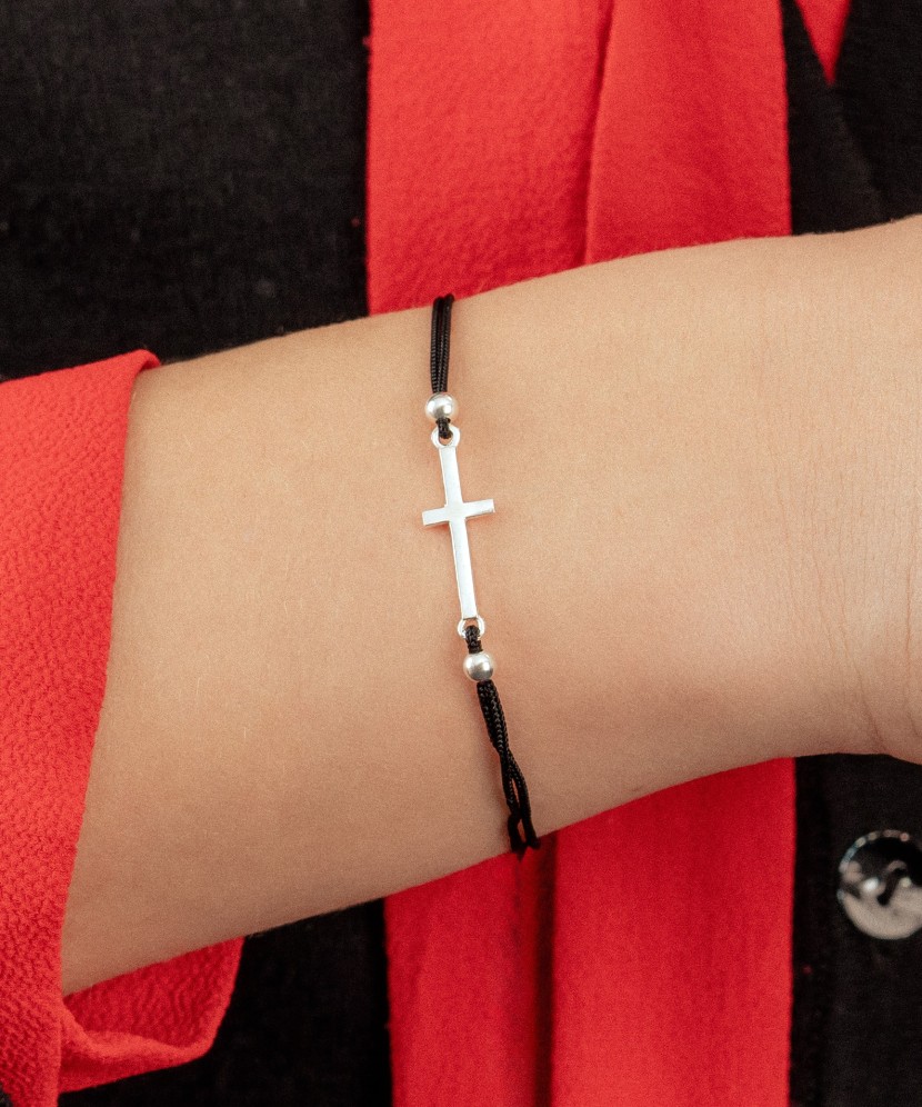 Black string bracelet with a silver pendant