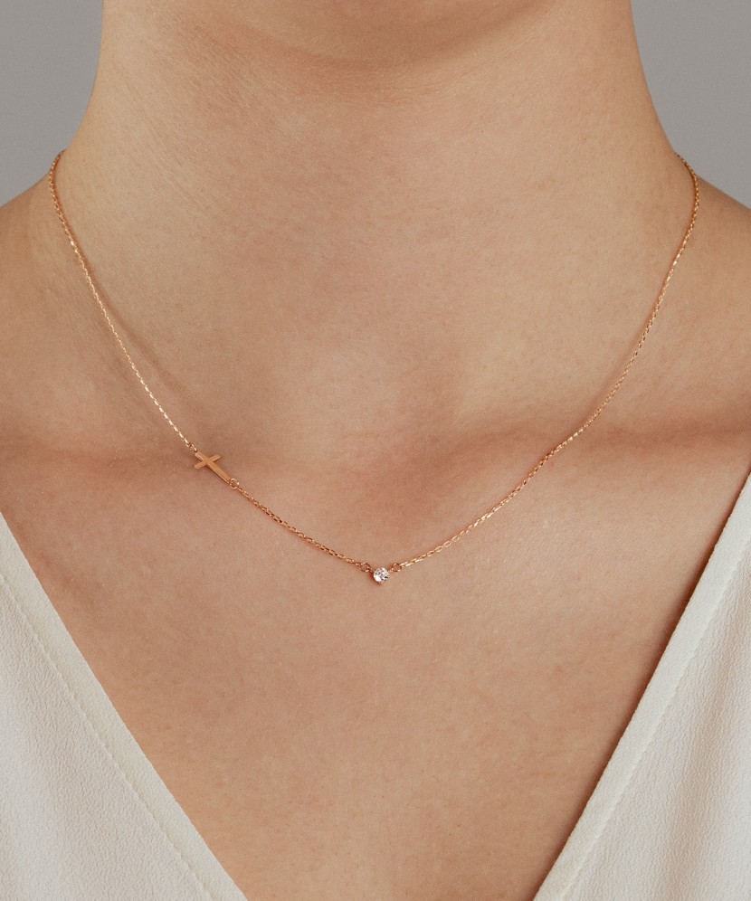 Gold necklace with a zircon pendant and a cross