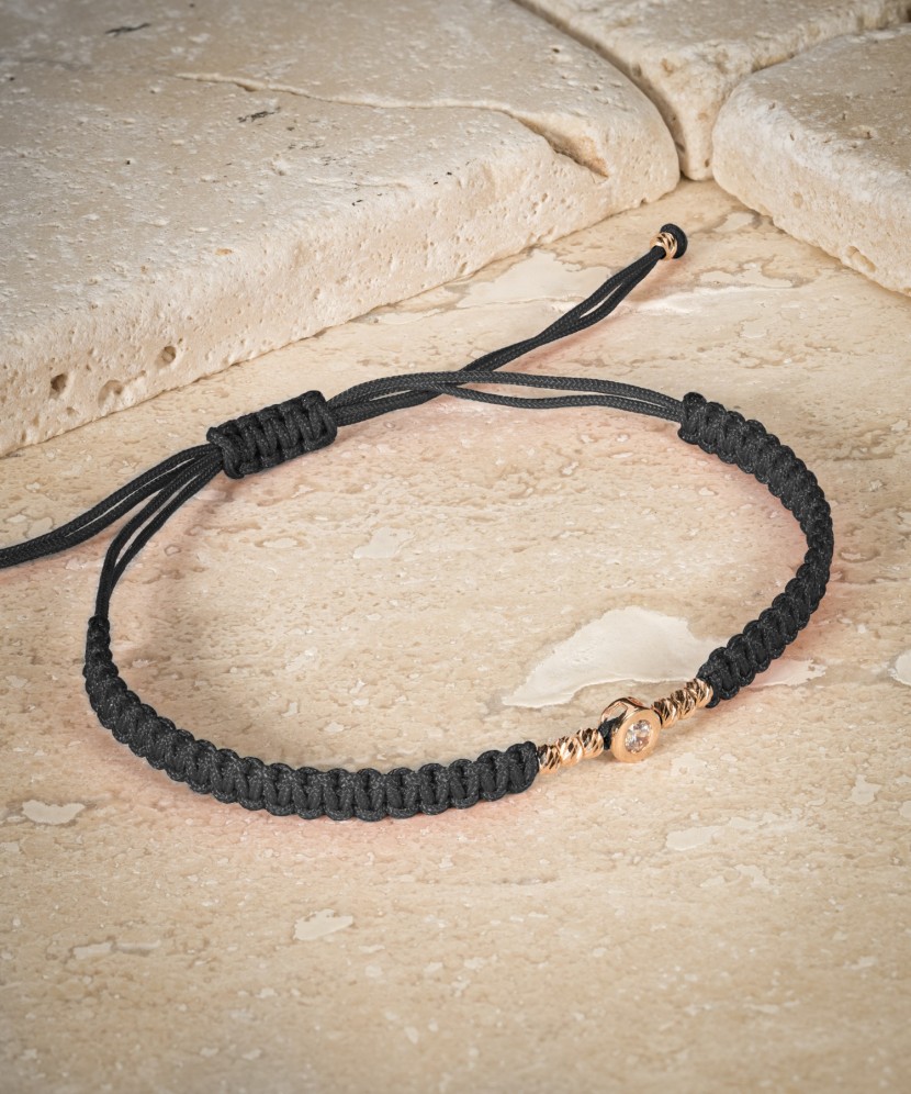 Black string bracelet with gold pendant