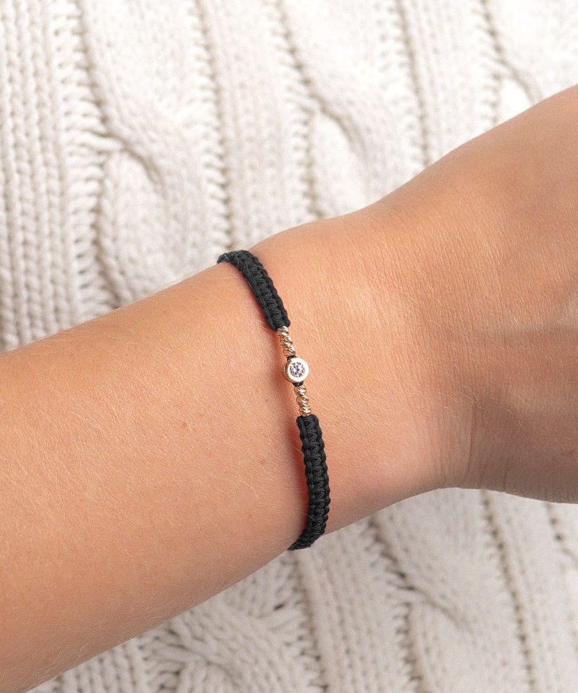 Black string bracelet with gold pendant