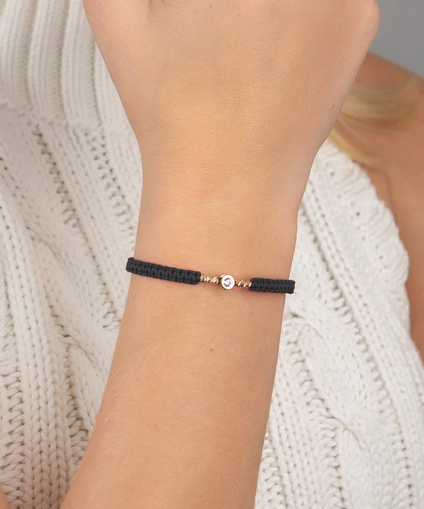 Black string bracelet with gold pendant