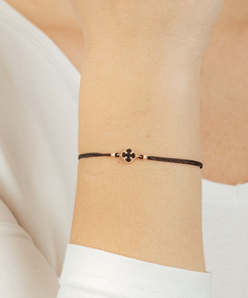 Black string bracelet with gold and onix