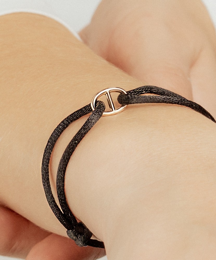 Black string bracelet with gold