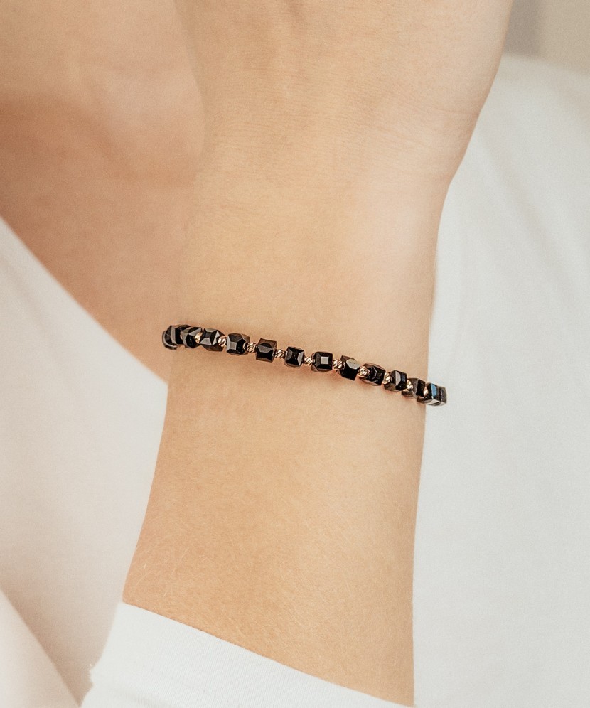 Black string bracelet with gold and onyxes