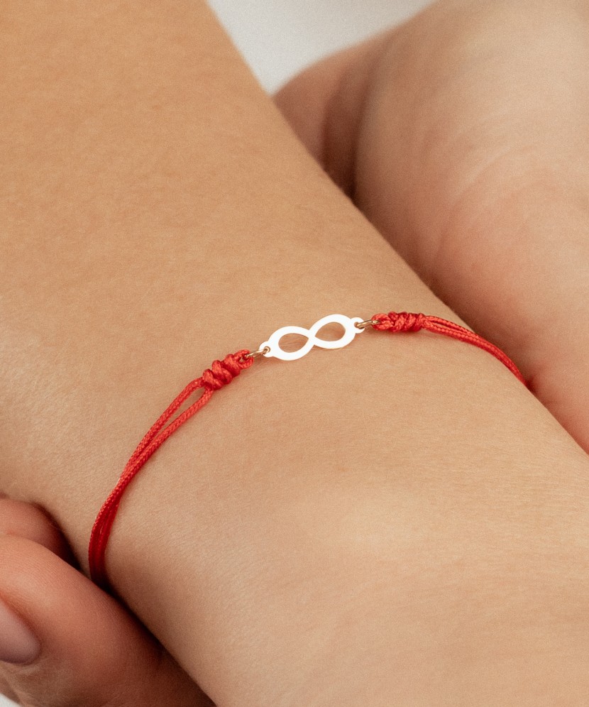 Red string bracelet with gold pendant "Infinity"
