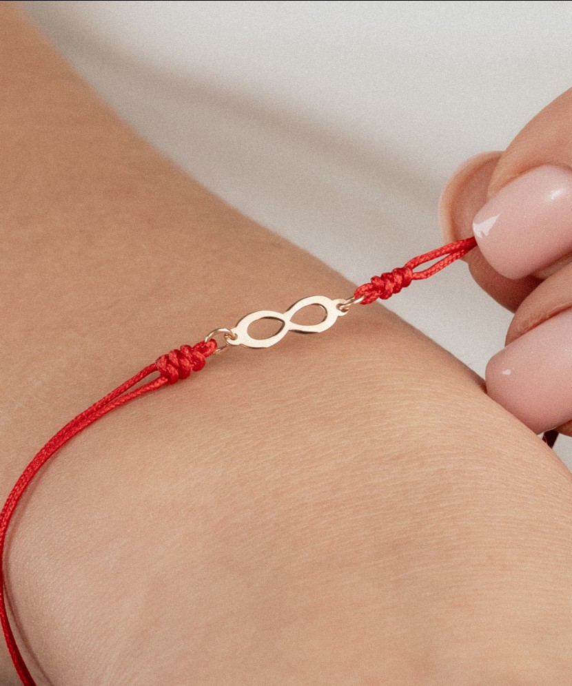 Red string bracelet with gold pendant "Infinity"