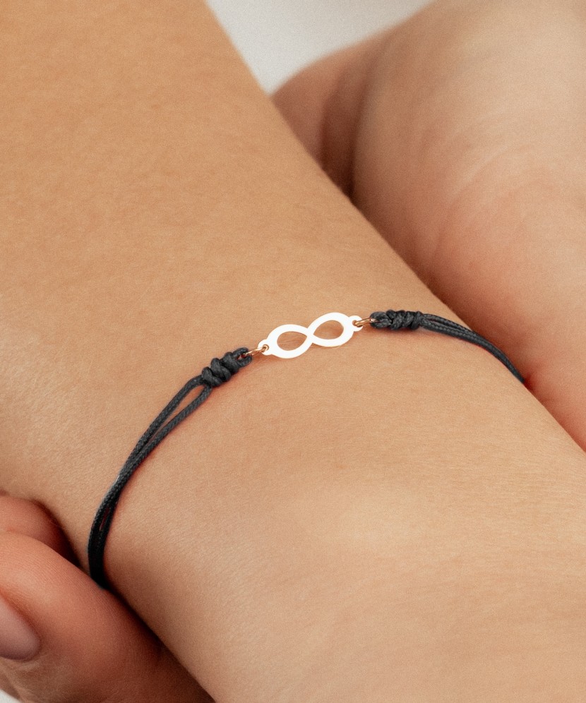 Black string bracelet with a gold pendant “Infinity”