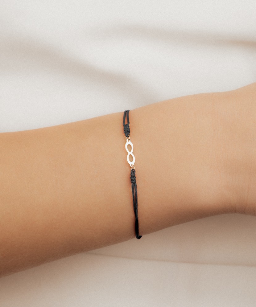 Black string bracelet with a gold pendant “Infinity”