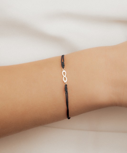 Black string bracelet with a gold pendant “Infinity”