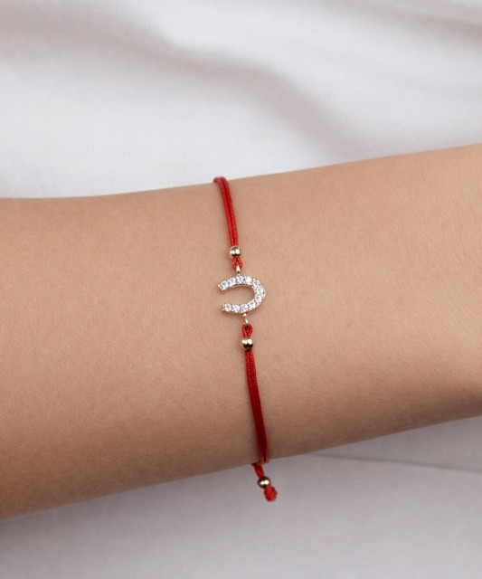 Red string bracelet with gold pendant