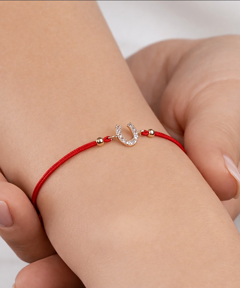 Red string bracelet with gold pendant