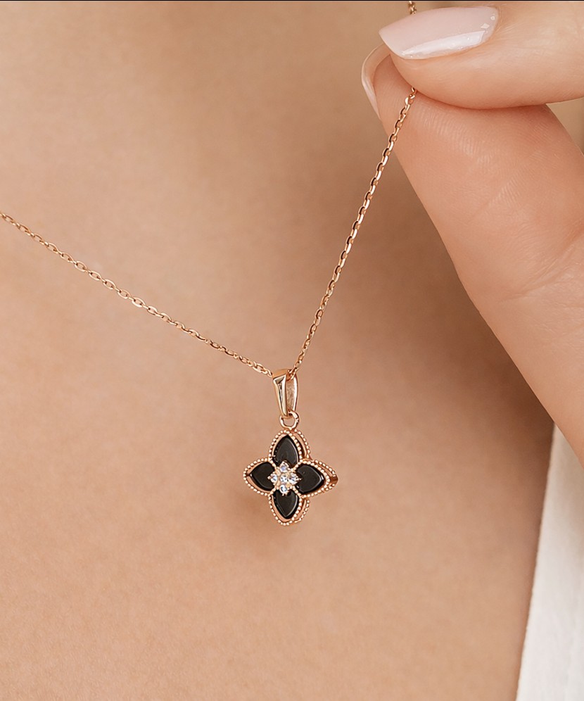 Gold pendant with onyx and zircons