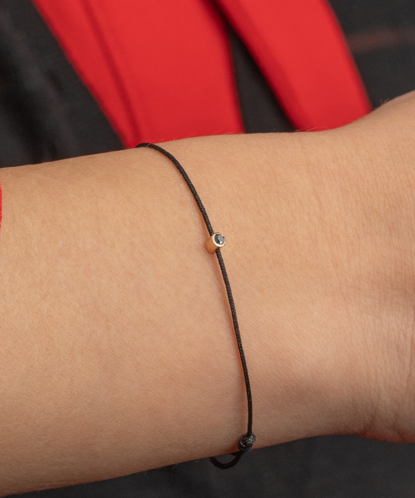 Black string bracelet with black diamond and yellow gold