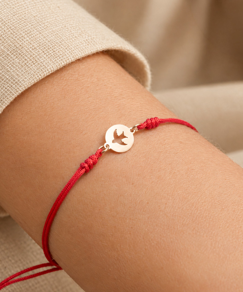 Red string bracelet with gold pendant