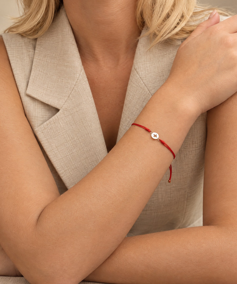 Red string bracelet with gold pendant