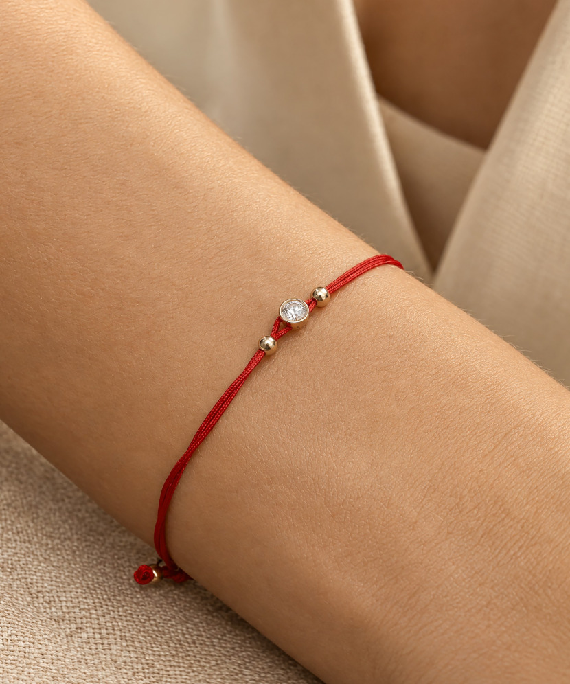 Red string bracelet with gold zirconia pendant