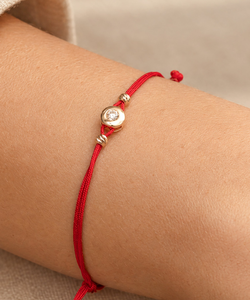 Red string bracelet with gold zirconia pendant
