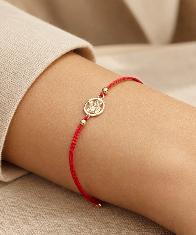Red string bracelet with gold