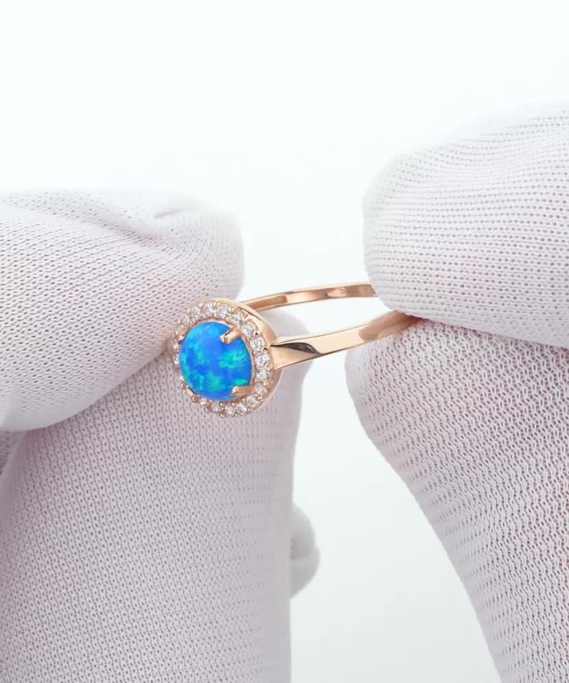 Gold ring with zircons and opal