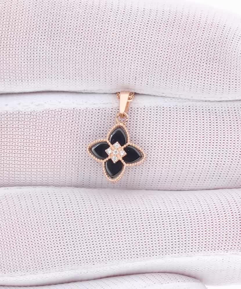 Gold pendant with onyx and zircons